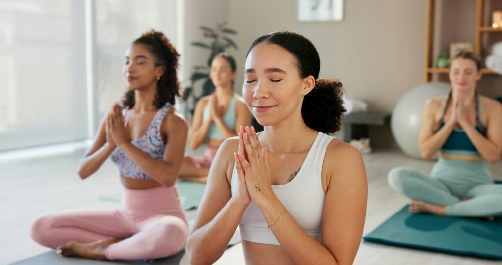 Fitness, group and women with yoga, meditation and breathing with routine, hobby and class for heal